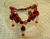 Red & Black Beaded Stretch Charm Bracelet With Glass Lady Bugs
