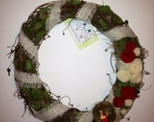 Grapevine wreath with moss, felt roses, bird in nest & burlap.