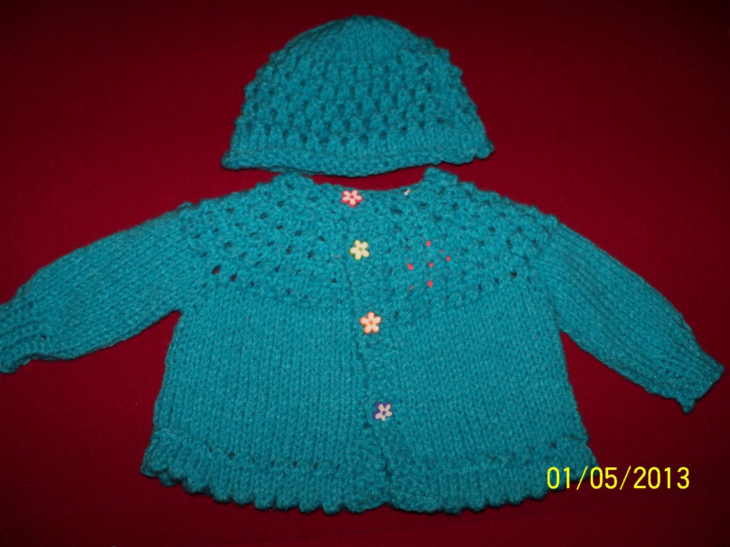 Aqua sweater and hat with flowered buttons. Machine wash/dry.