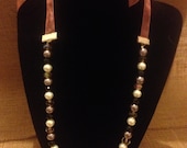 Hand beaded pink ribbon necklace with silver and white pearls with black and clear crystals. 