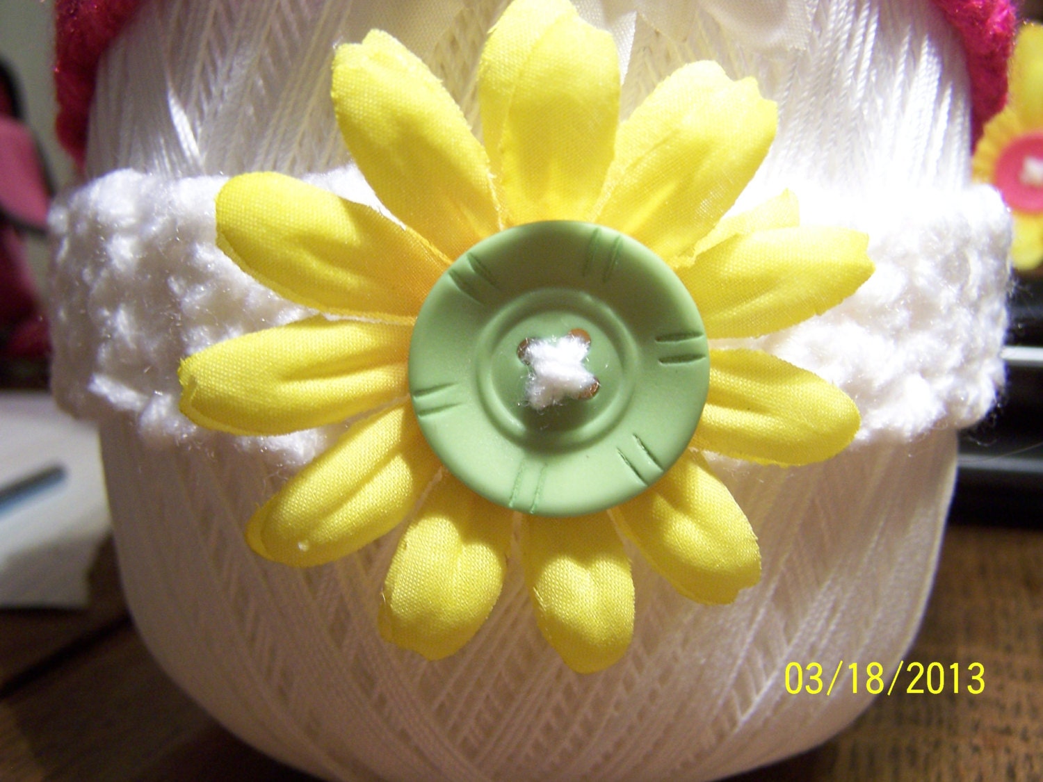 3-9mos white headband with yellow nylon flowers and a lime green button