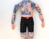 Side Glancing Tattoo Man Doll