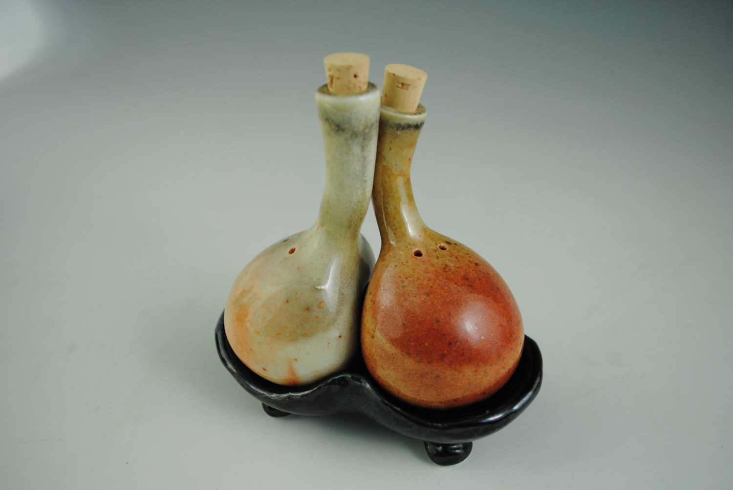 Salt and Pepper Shakers, Orange and Tan on Black Tray