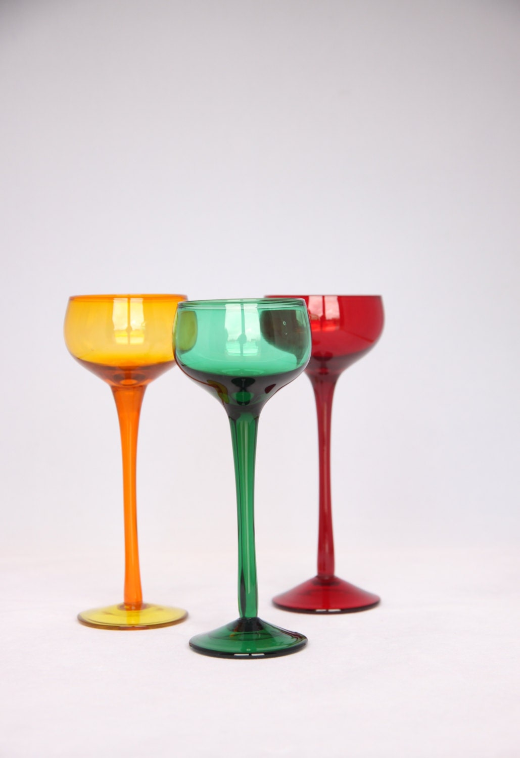 Stunning mid century colourful aperitif glasses, modern red yellow and green glasses on a high base