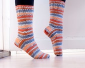Striped socks in durable woolblend yarn in orange, tangerine and gray.