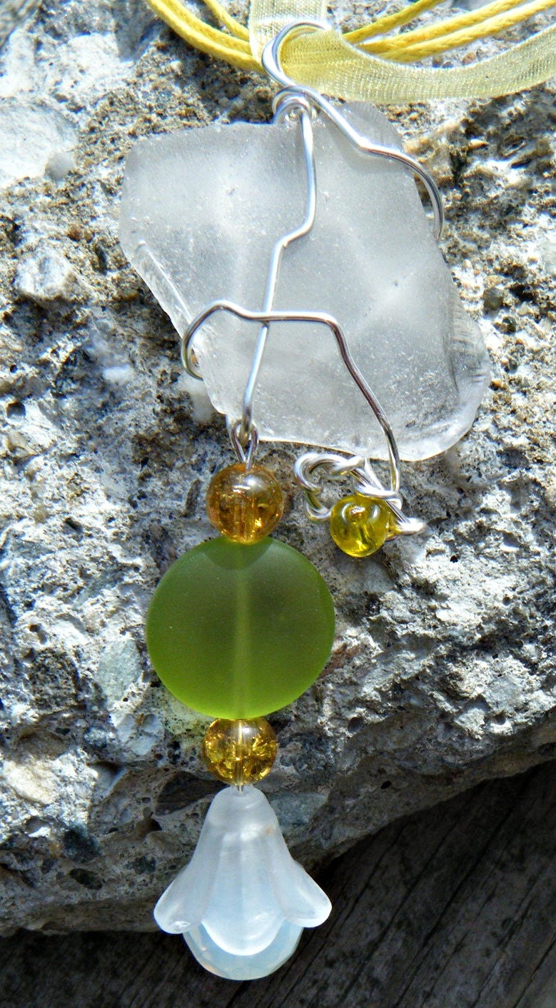 Wire Wrapped Sea Glass Necklace with glass beads. Clear sea glass necklace with green sea glass and a trumpet flower