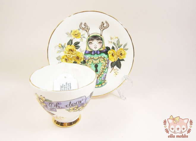 Vintage Tea Cup and Saucer with a Lock Pick Russian Doll Illustration