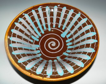 Ceramic serving bowl with colored slip decoration and golden brown glaze