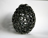 Metallic black decorative egg. Ceramic sculpture, home decor.