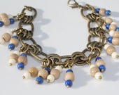 Antique Brass Bracelet with Navy Blue, Natural Light Brown, and White Tagua Nut Charms