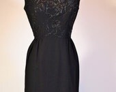 Vintage 1960s sleeveless black cocktail dress LBD by designer Susan Small with floral embroidery and beading with flap detail at back