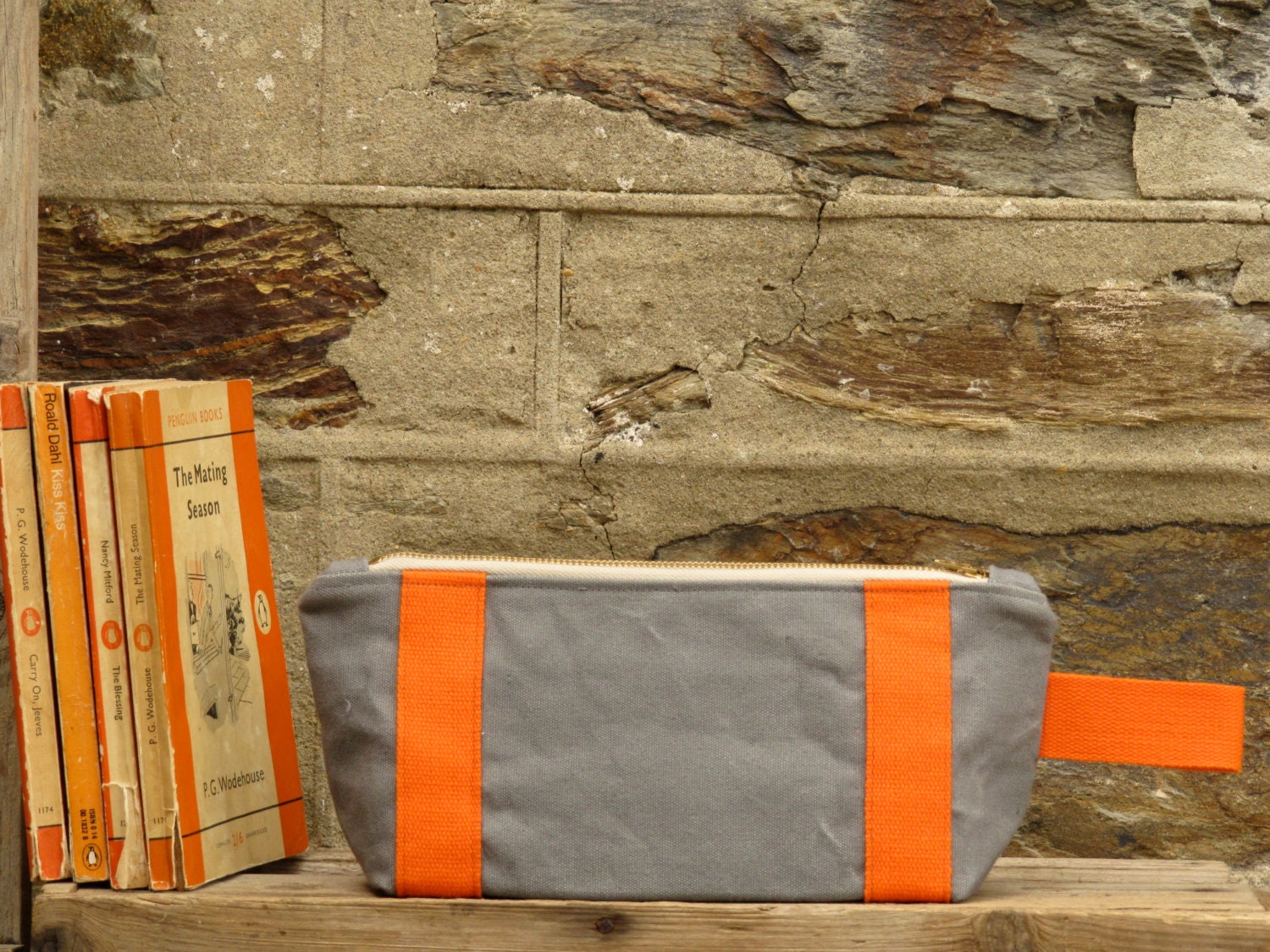 Bright and bold Zip pouch/ toiletry bag. Ticking stripe lining. Industrial grey washed thick canvas. Orange accents, and a YKK brass zip.