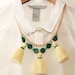 Cream yellow tassel double layer necklace with green beads