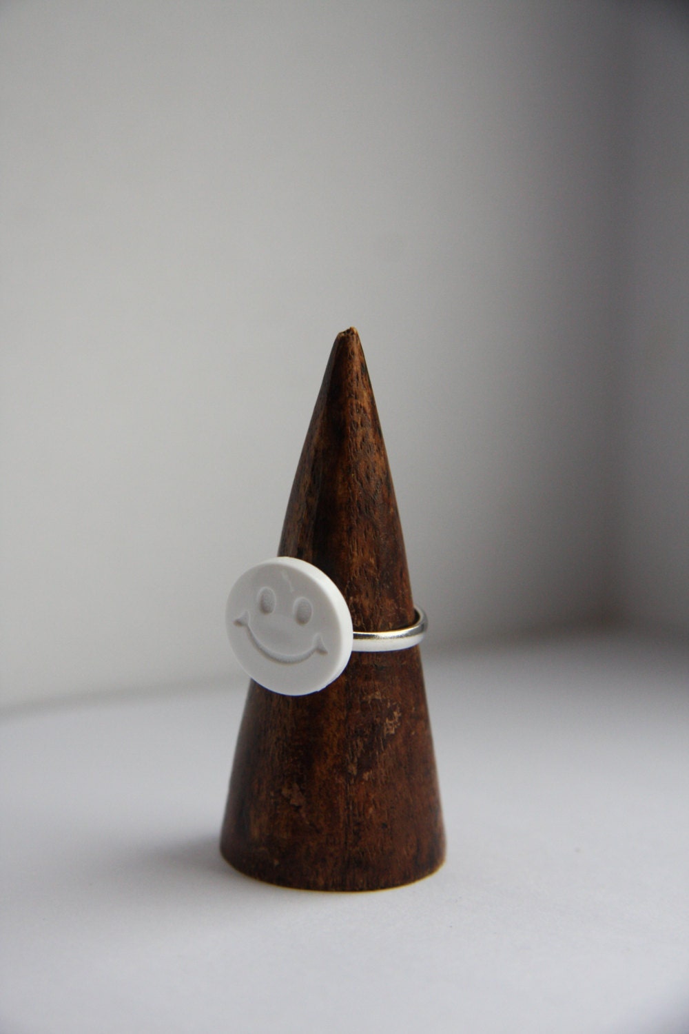 White Smiley Face Button on Adjustable Silver Plated Ring.