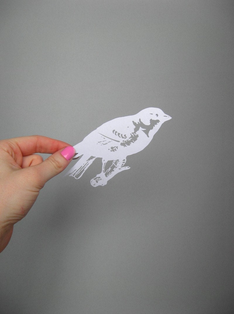 Paper-cut Scherenschnitte silhouette Finch on a Twig in Snow White