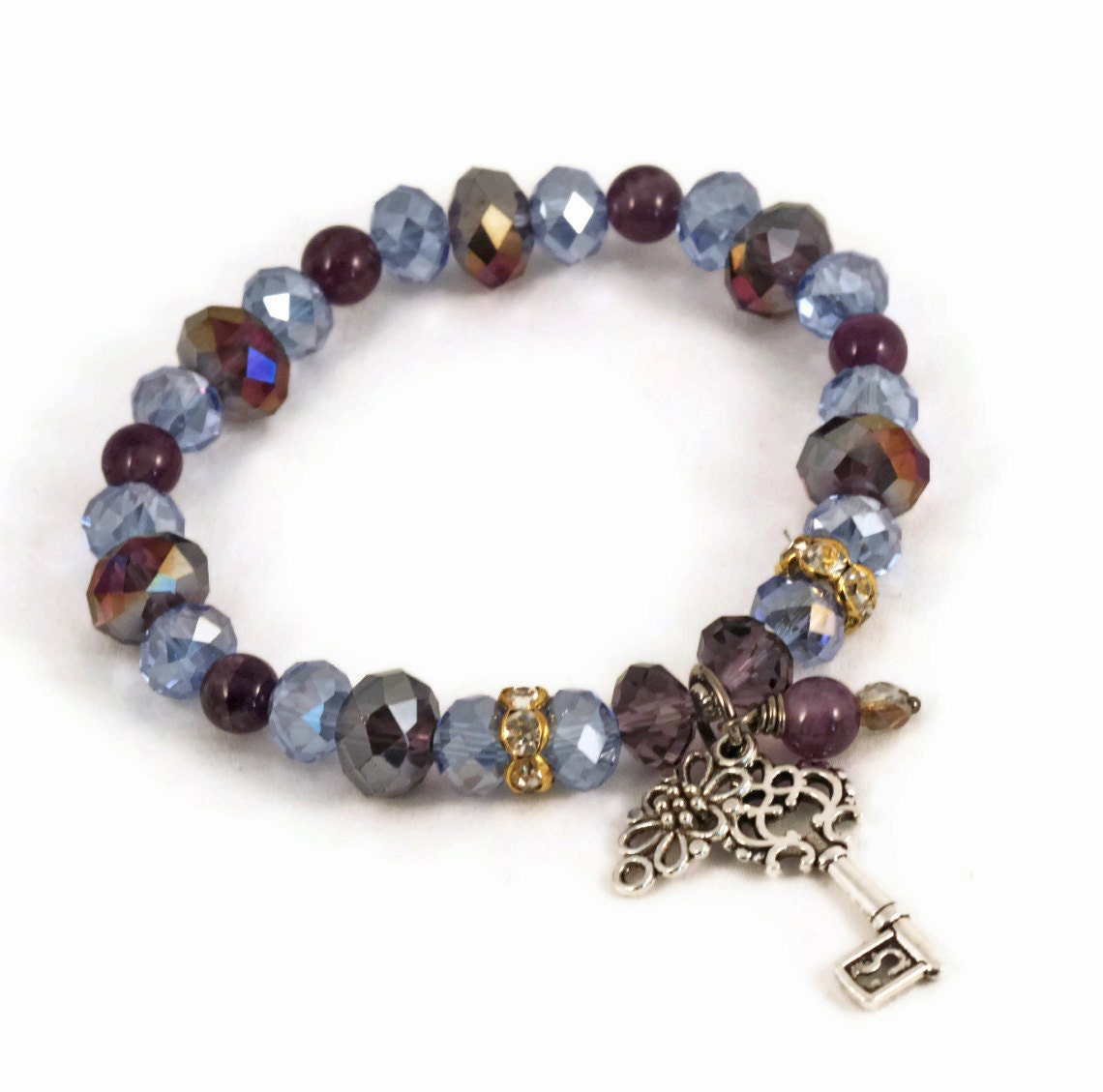 Crystal and amethyst stretch bracelet with key charm, violet, blue, grape, purple