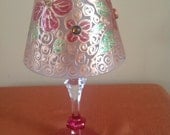 Two piece candle holder.  It has a wine glass base, and a frosted glass lampshade.