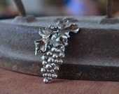 A Bacchanalian Brooch, a cluster of grapes chased and repoussed in sterling silver