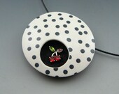 Mid century modern style pendant necklace in black and white polymer clay with cherry accent