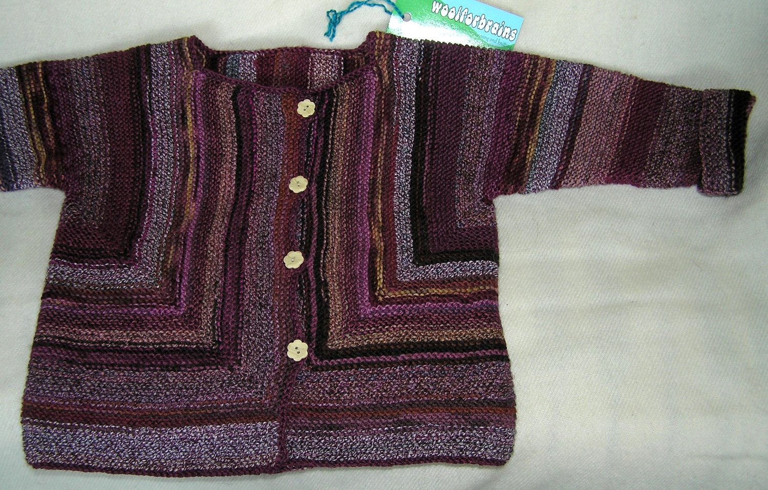 Handknitted pink and brown striped baby jacket