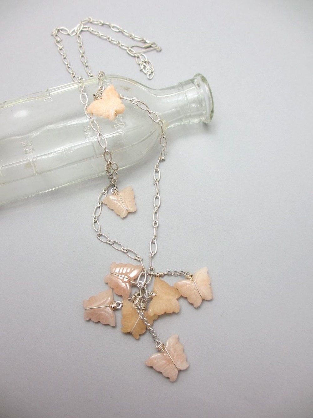 Peach Butterflies. Carved quartz butterflies clustered on long adjustable necklace