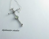 off kilter sterling silver hand forged cross with calcedony stone and sterling silver chain