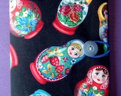 Russian doll passport cover made with a rare fabric with a button elastic loop closure