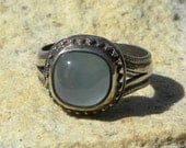 Ornate oxydized sterling silver ring with aquamarine cabochon
