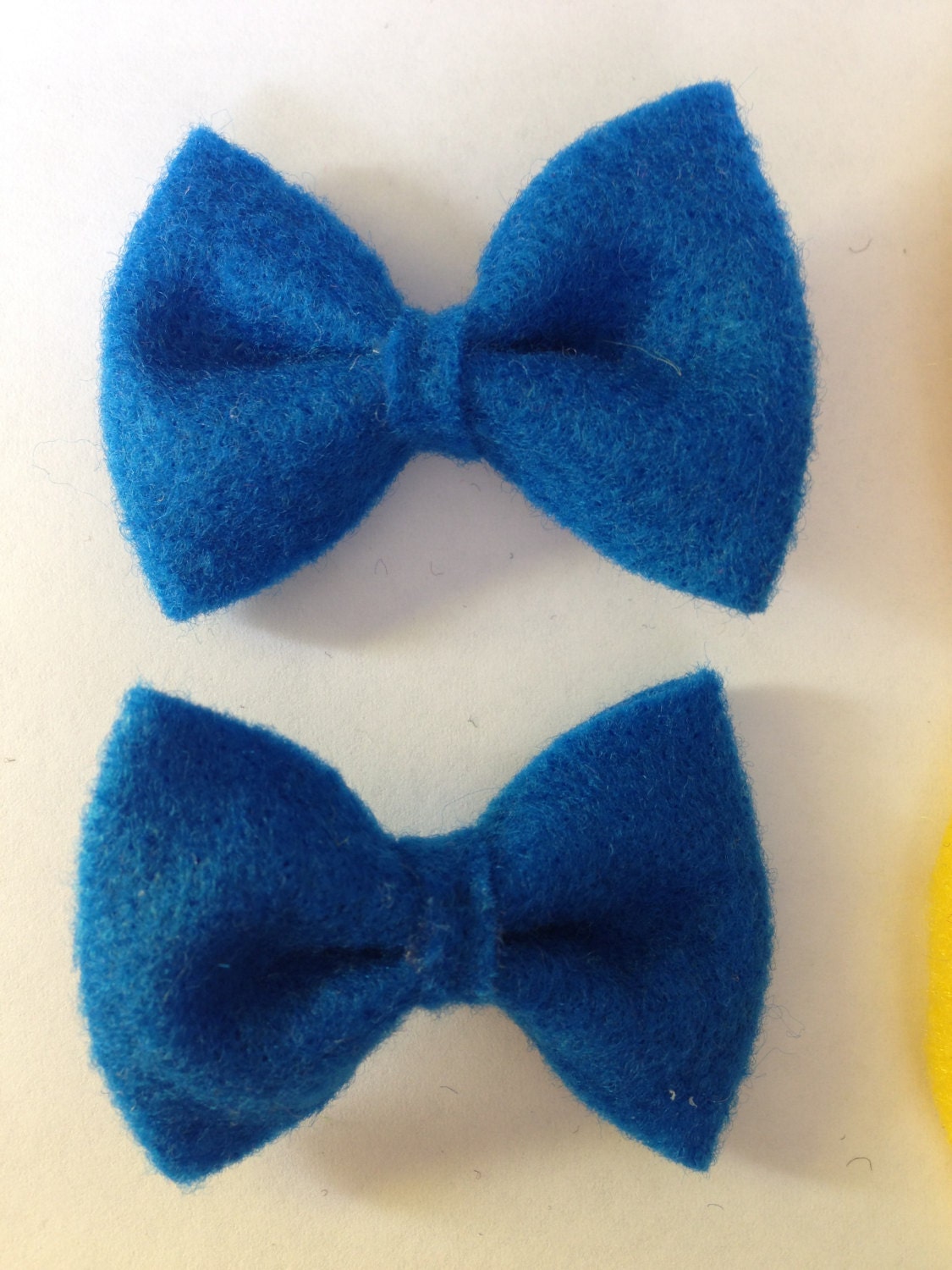 Two pair pigtail bows, blue and yellow