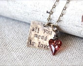 All you need is love.  Quote inspirational charm necklace by Sweet And Simple Jewelry Design.  Hand stamped brass with Swarovski Wild Heart.