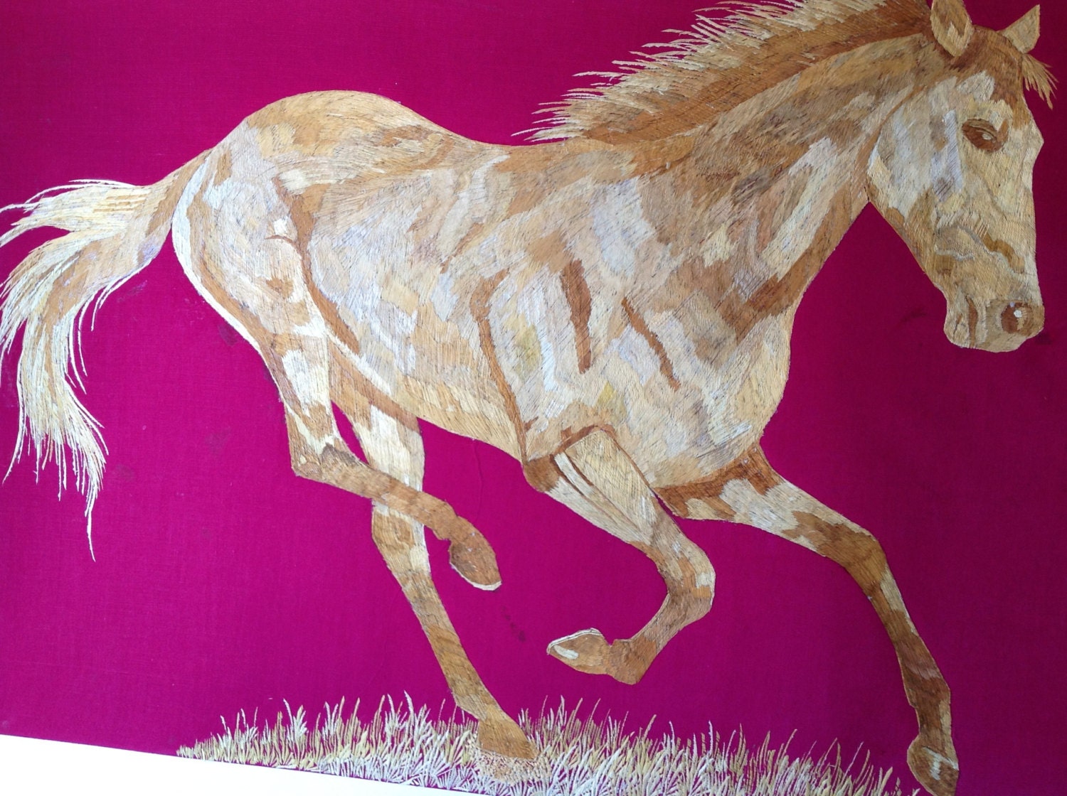 Horse galloping in rice straw art. Handmade with dried leaves of rice plant. Ancient leaf art collectible