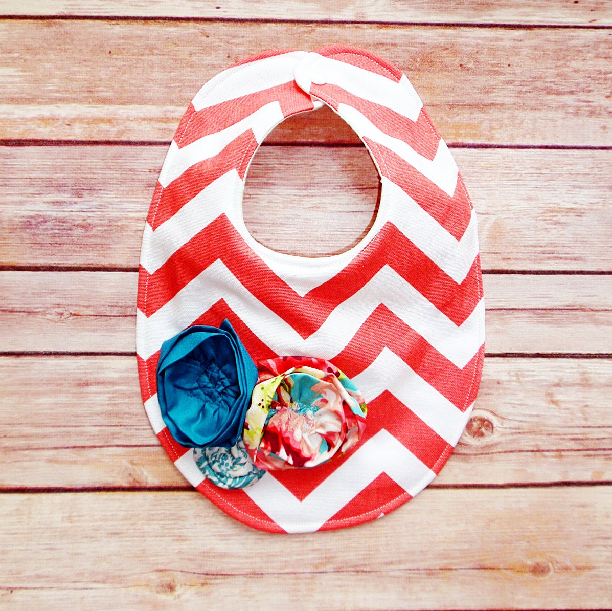 Coral chevron baby bib with turquoise flowers