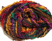 handspun art yarn Impact 64 yds thick and thin rainbow red  thread plied yarn, knitting supplies crochet supplies