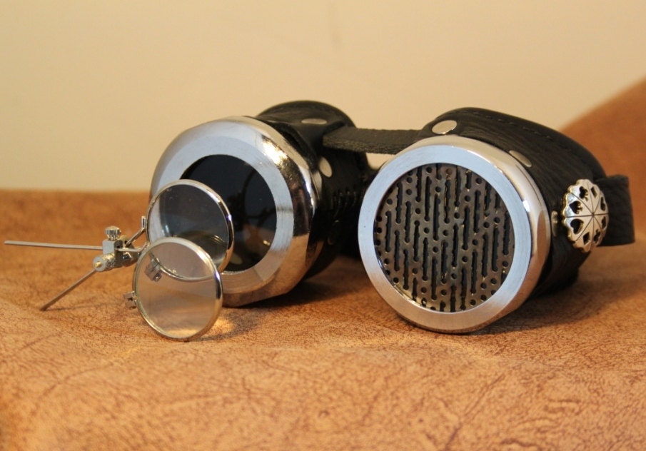 Steampunk goggles, black and silver with screen over one eye and magnifiers on the other