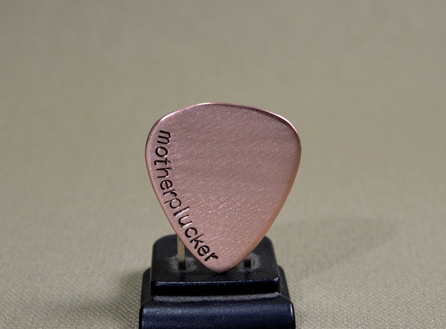 Copper motherplucker guitar pick