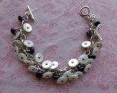 Handmade vintage plastic faux mother of pearl and blue shoe buttons silver tone metal bracelet. One of a Kind.