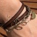 multi wrap dark brown togo flat leather bracelet with brass leaf connector and bird