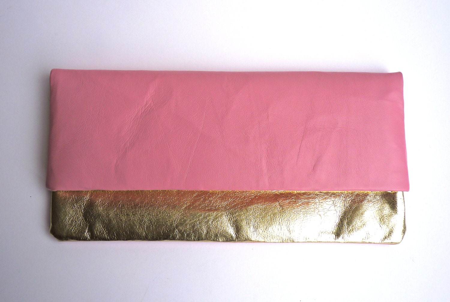Leather foldover clutch bag in metallic bleached gold and baby pink