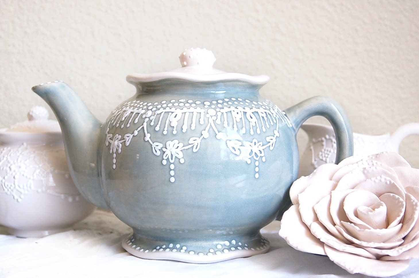 Sweet grey teapot detailed with white accent