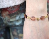 Bracelet with small hearts and pink glass stones