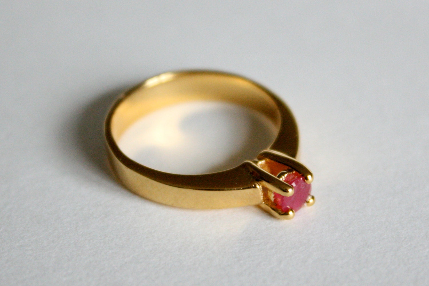 Faceted Ruby Solitaire in Gold