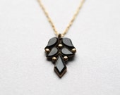 worlds apart. black glass charm and vintage brass mourning necklace.