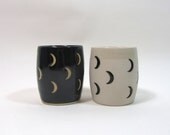 Pair of crescent moon cups, black and unglazed