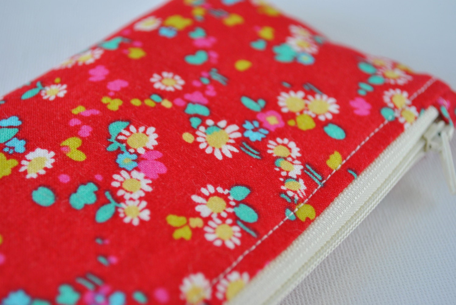 Padded camera pouch: Liberty of London retro daisy floral print in pinky red,aqua blue yellow and white.