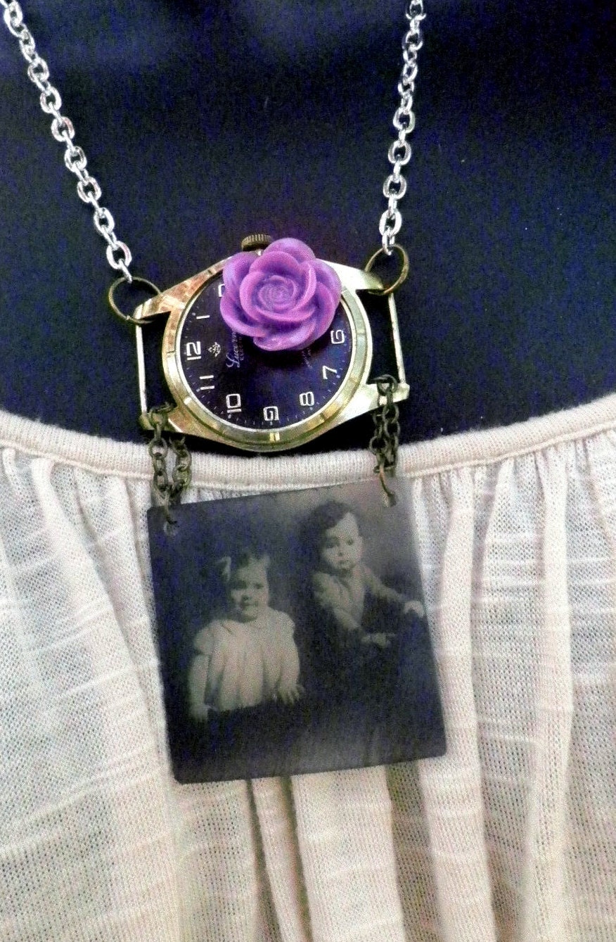 Layered assemblage of old vintage watch and pendant with antique pic of siblings.