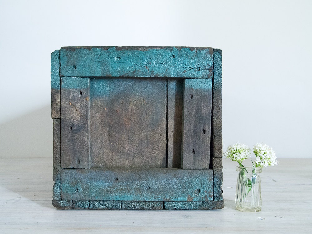 vintage industrial wooden crate with blotchy teal paint
