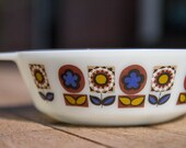 Vintage Pyrex casserole with retro blue and brown flower pattern
