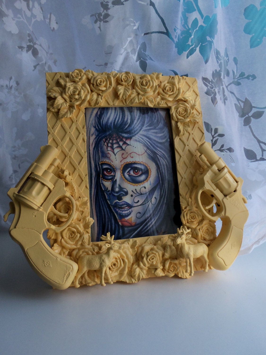 yellow guns, roses, and deer picture frame