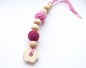 Pink small floral teething for baby. Natural wooden toy with organic cotton.