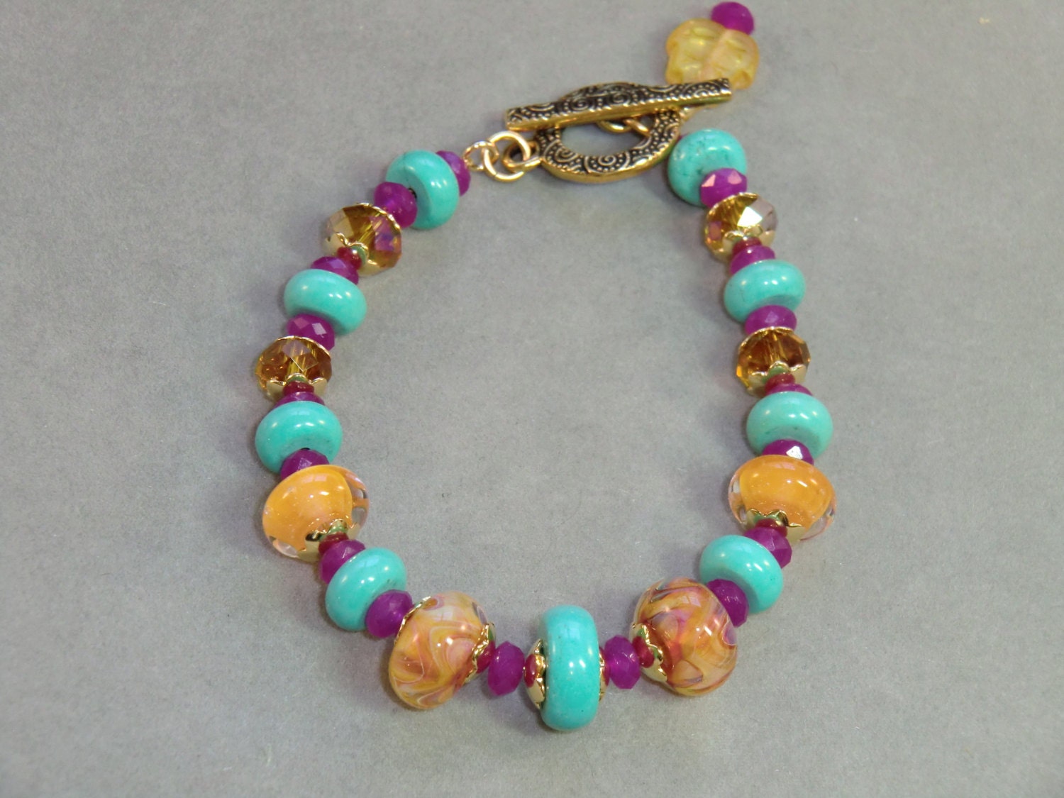 Turquoise, yellow, and fuchsia lampwork bracelet, Mexicali bracelet in howlite and quartz in pink, blue and gold